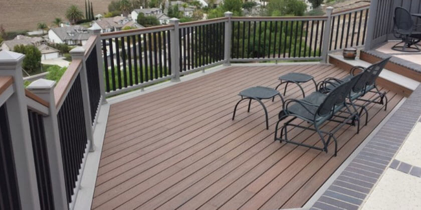 Residential deck area with outdoor furniture overlooking a suburban neighborhood, crafted by a professional deck builder in Malden, CA.