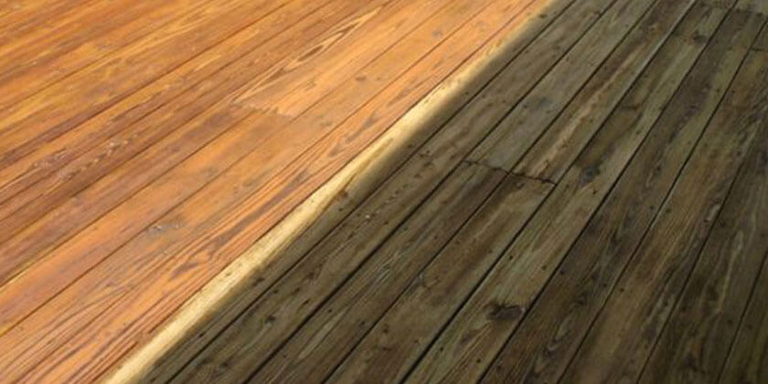 Refinished hardwood floor next to old, worn planks, showcasing a before and after contrast by a skilled contractor.